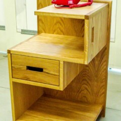 white oak nightstand with off center drawers and shelves