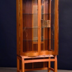 wood cabinet with curved glass doors