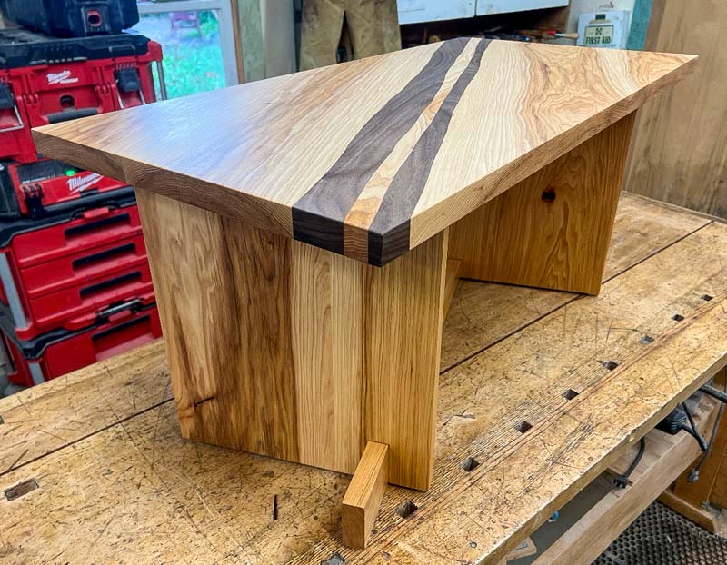 wood table with inlaid diagonal stripes on workbench